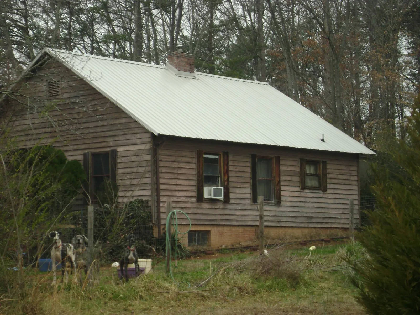 White metal roof on an old wood sided farmhouse, from a Metal Roof Installation job in Kamrar